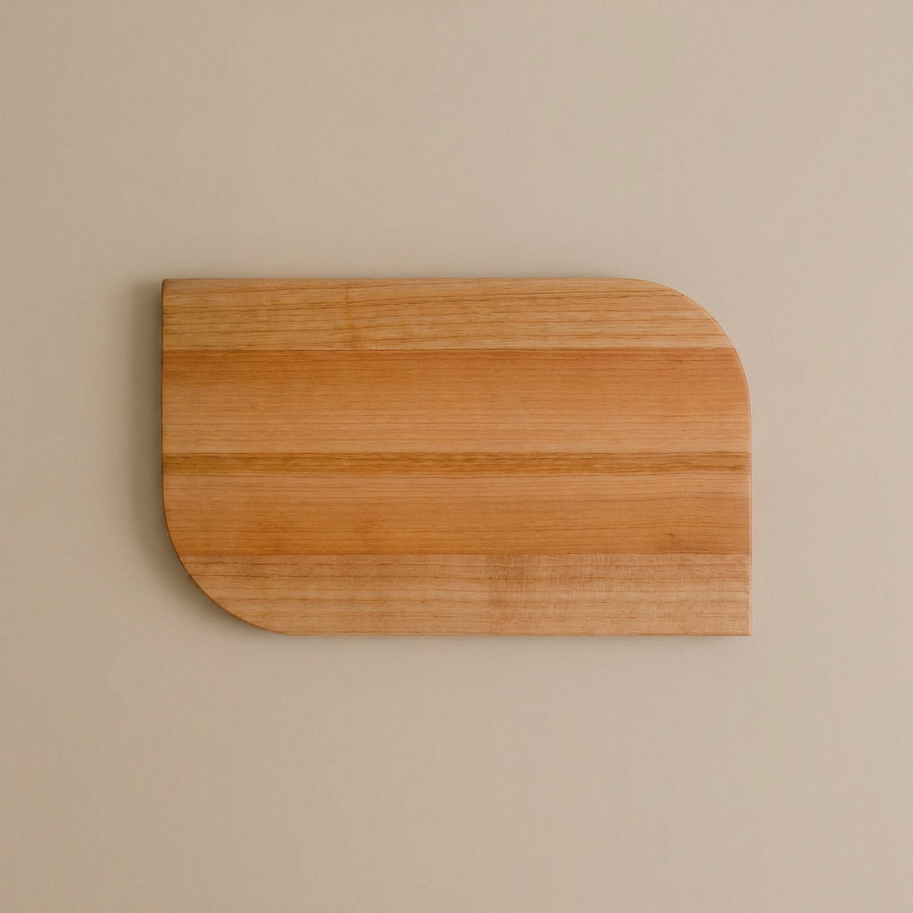 Kleines Schneidebrett aus einem Stück Talino Kirsche auf beigem Steinboden 03